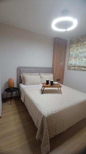 a bedroom with a bed with a table on it at Thermi Luxury apartments in Thermi