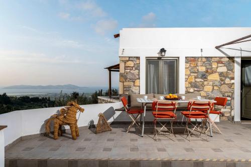 a house with a patio with a table and chairs at Infinity III - Tranquil Studio Retreat in Kos in Lagoúdi Zía