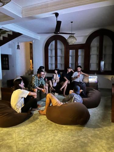 a group of people sitting on bean bags in a living room at Coco Drift Hostel Hiriketiya in Hiriketiya