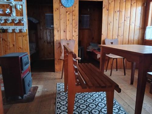 a dining room with a table and a stove at Chata - Na samotě u lesa in Levín