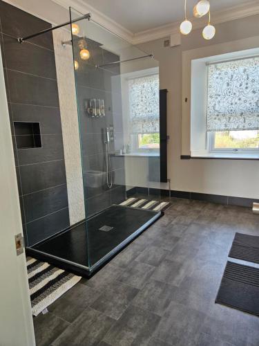 a bathroom with a shower with a glass door at The Old Bank bed & breakfast in Millport