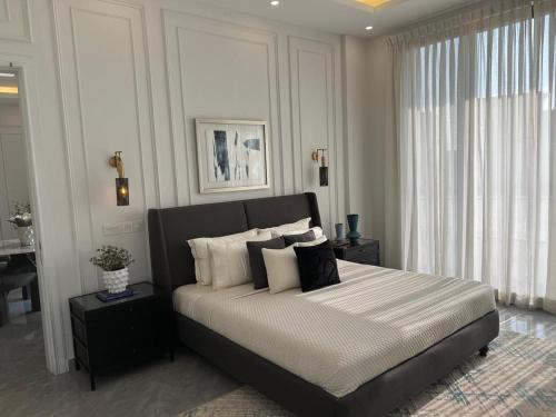 a bedroom with a large bed with pillows on it at Two Bed Appartment in Islamabad