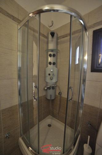 a shower with a glass enclosure in a bathroom at Guesthouse 4 Seasons in Árnissa