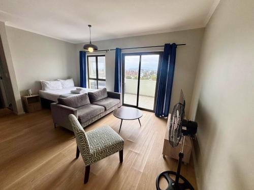 a living room with a couch and a bed at Cape Mae Apartment Hotel in Cape Town