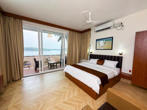 a bedroom with a large bed and a large window at Bella Vista Extended Stay in Kalyānpur