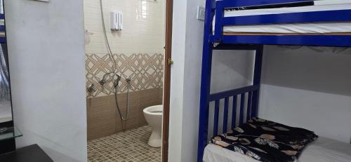 two bunk beds in a room with a toilet at Brighton Hostel Stays in Sultan Bathery