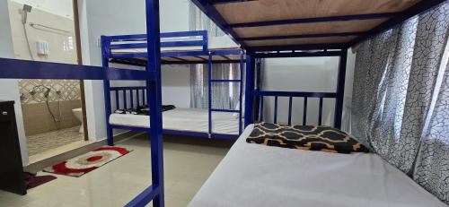 a bedroom with two bunk beds in a room at Brighton Hostel Stays in Sultan Bathery