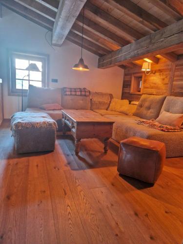 a living room with a couch and a coffee table at Les Chryolles -Les Petits loups in Valmeinier