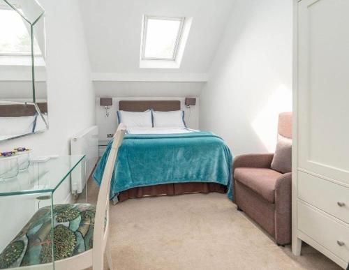 a bedroom with a bed and a chair and a window at Soofi House in Sheffield