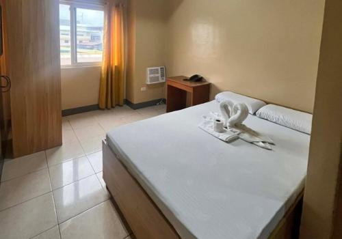 a bedroom with a bed with a angel on it at JL Suites by Hiverooms in Cebu City