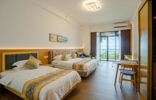 a hotel room with two beds and a table at Best Hotel in Johor Bahru