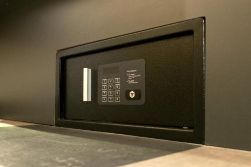a black and silver microwave on a black counter at easyHotel Amsterdam Arena Boulevard in Amsterdam