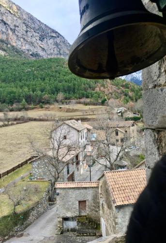 a view of a village from a bell at Casa de piedra Siglo XVIII in Badaín