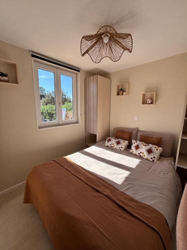 a bedroom with a large bed and a window at Chalet Cosy 6 personnes in Gassin