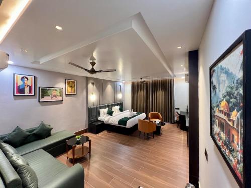 a living room with a couch and a bed at Hotel Mango Groves in Kotdwāra