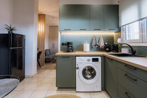 a kitchen with a washing machine and a sink at Zoe's Luxury Living in Volos