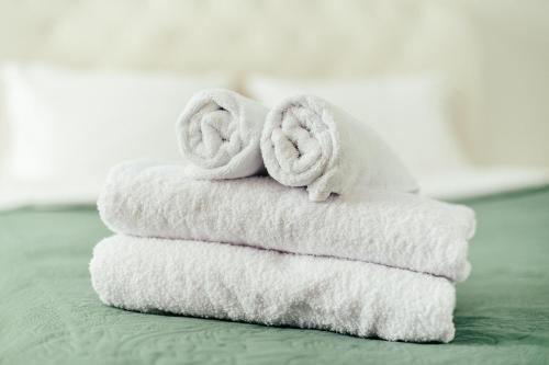 a stack of towels with two donuts on them at Central Park Apartment 4 Guests in Chişinău