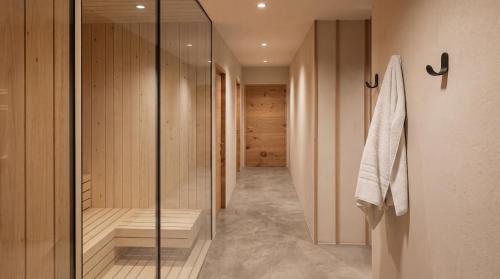 a walk in shower with a glass door in a bathroom at Butični Hotel Sončno Polje in Moravske-Toplice