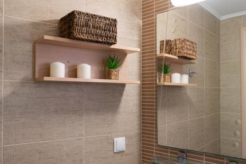 a bathroom with wooden shelves on the wall at Villa Avra in Panormos Rethymno