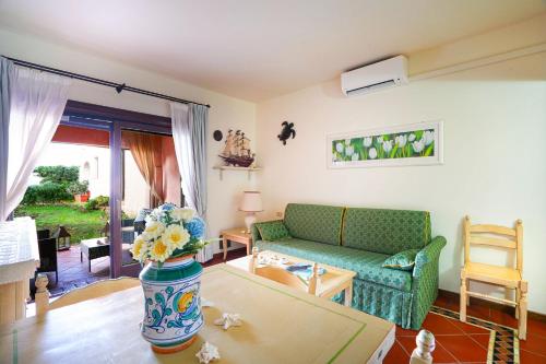 a living room with a couch and a table at Cala Del Faro House in Arzachena