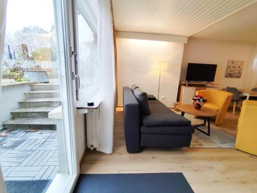 a living room with a couch and a chair at Ferienwohnung Iris in Radolfzell am Bodensee