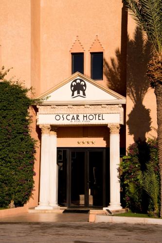 an ocear hotel sign in front of a building at Oscar Hotel by Atlas Studios in Ouarzazate