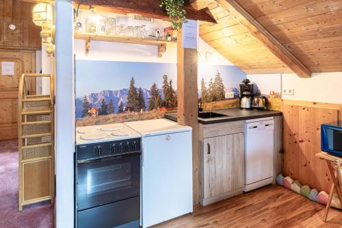 a kitchen with a stove and a refrigerator at Haus Antonia in Wallgau