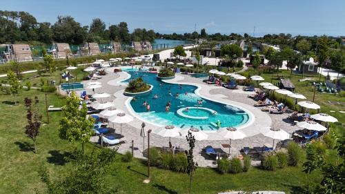 an aerial view of a swimming pool with umbrellas at Bungalow Marina Azzurra in Lignano Sabbiadoro