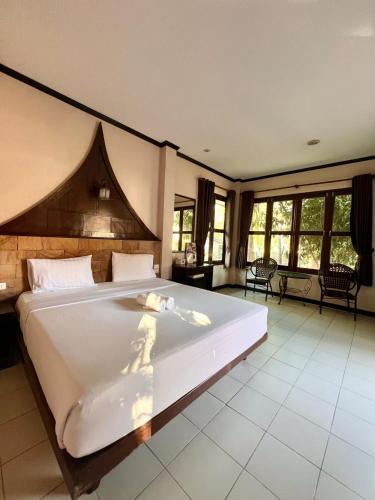a bedroom with a large white bed in a room at IYARA b in Ban Map Khangkhao