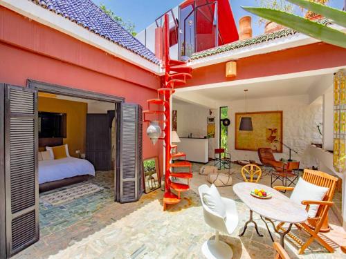 a room with a bedroom and a bed and a table at Palais Laila in Tighfert