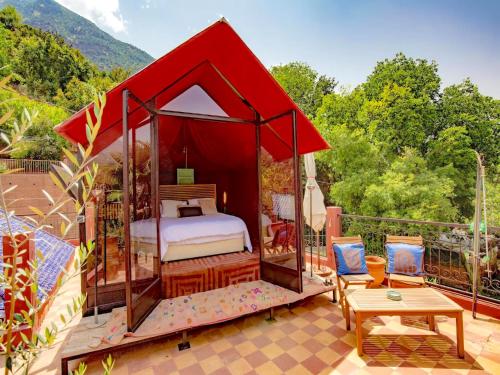 a bed in a gazebo on a patio at Palais Laila in Tighfert