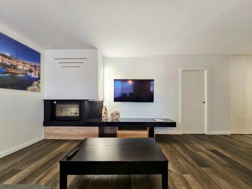 a living room with a table and a white wall at Ocean Breeze - Comfortable Ap Close to the Beach in Bicas