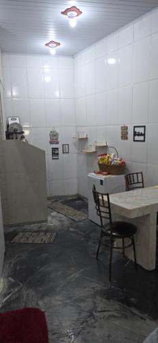 a kitchen with a table and a chair in a room at Kitnet próximo ao shopping in Campo Grande