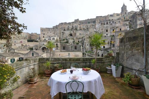 a table on a balcony with a view of a castle at Da Ida - In Lak' Ech in Matera