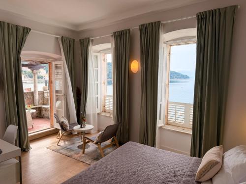 a bedroom with a bed and a view of the ocean at La Villa Lopud- Breakfast & Dinner Included in Lopud