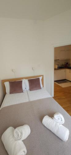 a bedroom with a bed with two towels on it at Apartment Green Lux in Belgrade