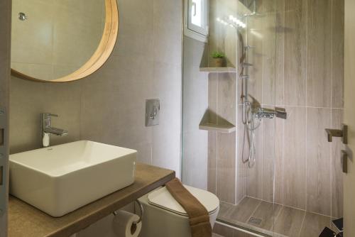 a bathroom with a sink and a shower and a toilet at Diana's Houses in Gythio