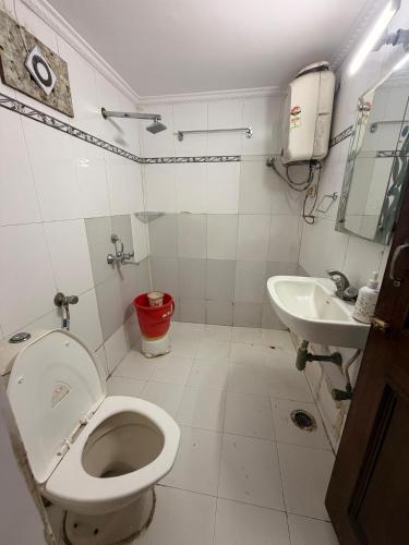 a bathroom with a toilet and a sink at Hotel SP international Lucknow in Lucknow