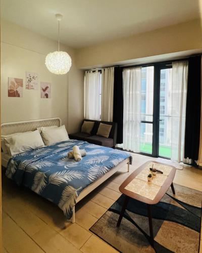 a bedroom with a bed with a stuffed animal on it at Henry's Newport Condotel in Manila