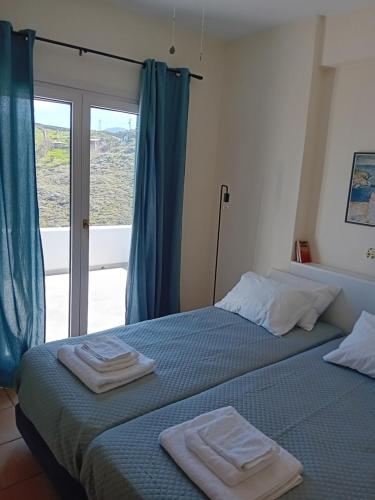 a bedroom with a bed with towels on it at Aethalios katoikia in Korissia
