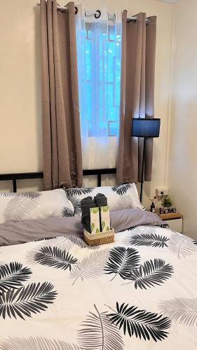 a bed with two pillows on top of it at The HappyNest Tagum in Tagum