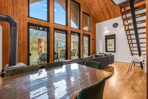 a living room with a large table and chairs at Cabana Alpinest & Sauna in Bran