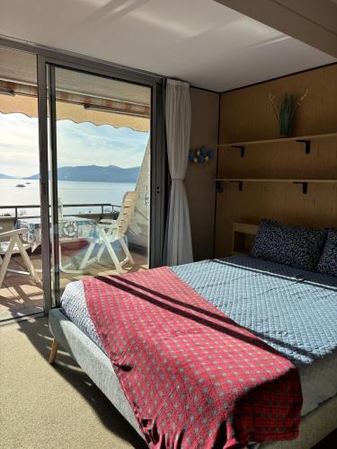 a bedroom with a bed and a view of the ocean at The Lookout in Ghiffa