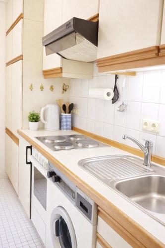 a kitchen with a sink and a washing machine at Stadthaus Sonneneck in Bad Tölz