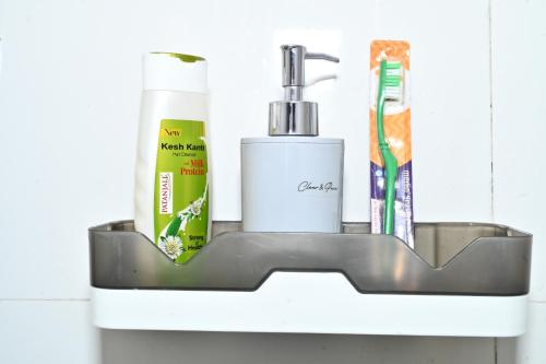 a bathroom shelf with a toothbrush and toiletries on it at Tatsaaraa Kavan in Rāmgarh
