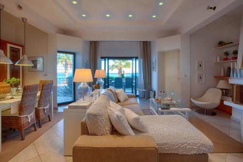 a living room with a couch and a dining room at Villa Sofias in Pefkochori