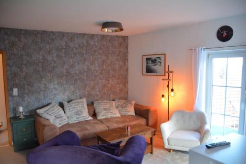 a living room with a couch and a chair at Zur Eresburg in Marsberg