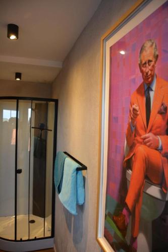 a painting of a man in a suit in a bathroom at Zur Eresburg in Marsberg