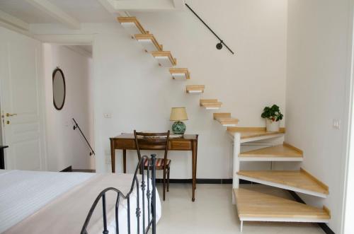 a bedroom with a staircase and a table and a bed at Casa Camelia - Cathedral View Apartment, 90m from Duomo in Noto
