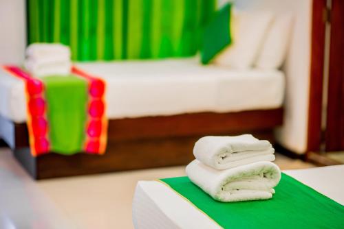 two towels sitting on a table in a hotel room at Miridiya Lake Resort in Anuradhapura